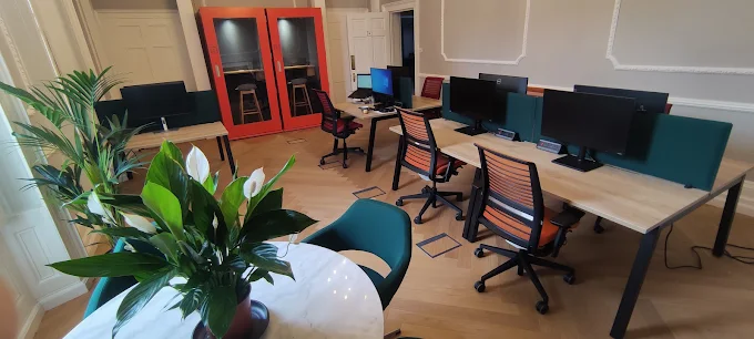 Modern hot desk workspace with monitors